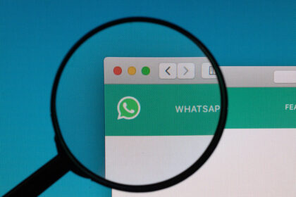 desktop displaying WhatsApp messages with a magnifying glass, symbolising the legal consequences of digital communication.
