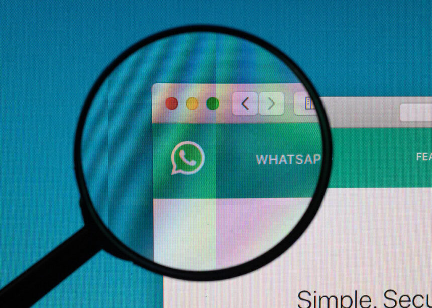 desktop displaying WhatsApp messages with a magnifying glass, symbolising the legal consequences of digital communication.