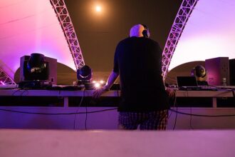 Close-up of a DJ sampling a vinyl record, symbolizing the tension between music remix culture and copyright law.