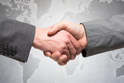 Illustration of global business contract negotiations with legal documents, a gavel, and international flags representing cross-border legal challenges.